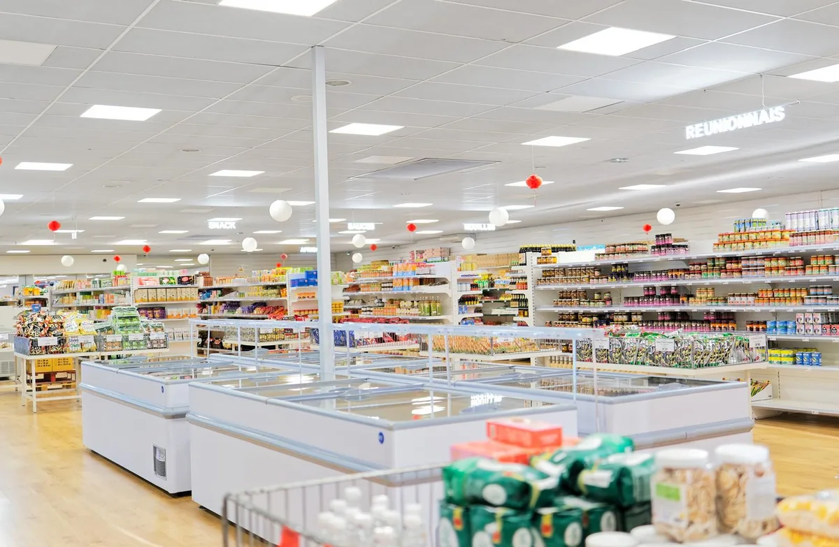 Allée des congélateurs et rayons d'épicerie chez H.ASIE